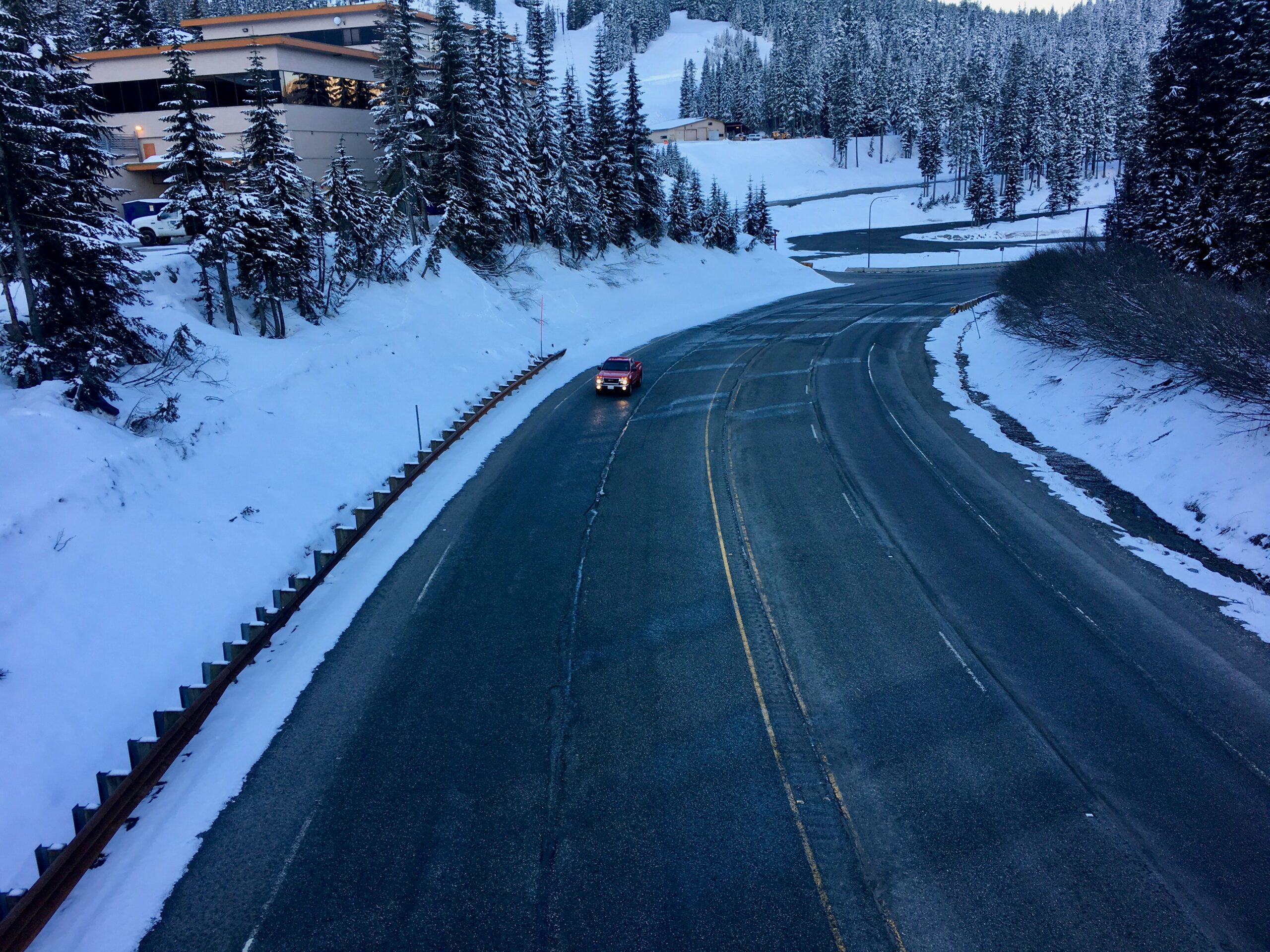 a car is driving down a snowy road